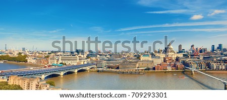 London, panoramic aerial view over Thames river with Millenium bridge, St. Paul and London skyline on a bright sunny day. Toned image.