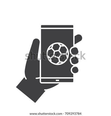 Hand holding smartphone glyph icon. Silhouette symbol. Smart phone soccer game app. Negative space. Raster isolated illustration
