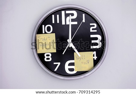 Wall Clock in a Office with a Note Over Nine and Five Royalty-Free Stock Photo #709314295
