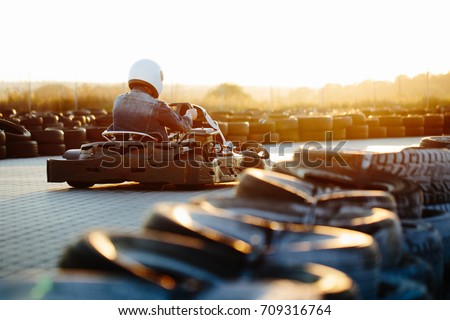 Karting competition or racing cars riding for victory on a racetrack Royalty-Free Stock Photo #709316764