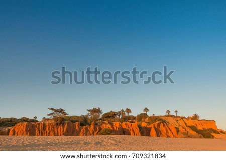 Blue Sky Red cliffs over beach