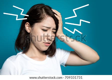 young woman having a headache. Royalty-Free Stock Photo #709331731
