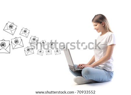 Smiling woman sending e-mails from a laptop