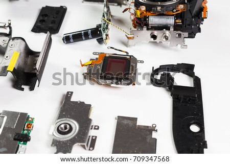 Repair broken digital SLR camera service center closeup.