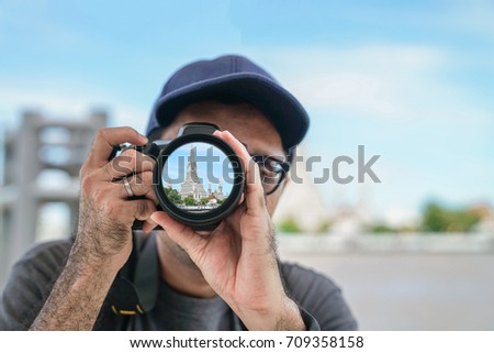Tourist Stock Photographer Take a photo during Travel around Bangkok Landmark in Thailand , Picture in len camera is overlap in post process 