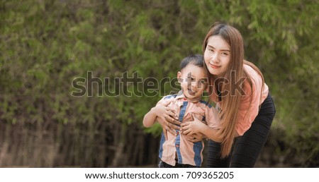 Mother play enjoying with her son in outdoor.