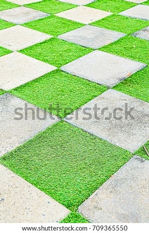 square cement floor with grass