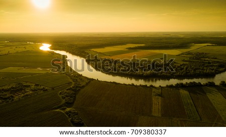 Orange sunset over beautiful river in Europe, aerial view from drone