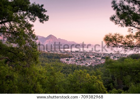 View of the city on the shores of the Mediterranean Sea in the rays of dawn