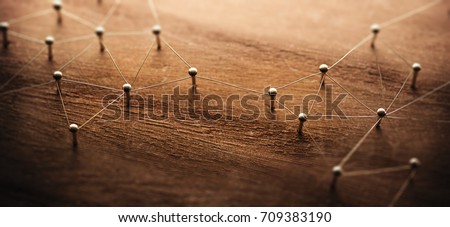 Connecting networks. Two separate network being connected with gold wire. Networking, social media, internet communication abstract concept image. Web of gold wires on rustic wood. Royalty-Free Stock Photo #709383190