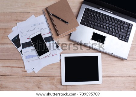 Home office for business Smartphone and a tablet and a laptop on the wooden background