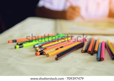 The boy drawing with coloring pencils, he is very happy,Education