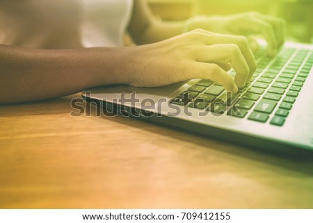 Employees' finger prints a trade report with a notebook computer.