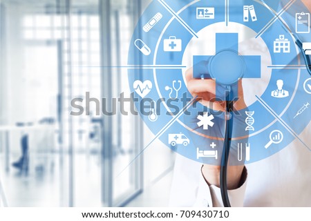 Health care and medical services concept with circular AR interface and female doctor using stethoscope Royalty-Free Stock Photo #709430710