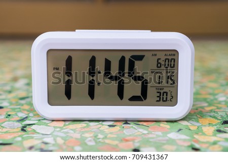 Digital Alarm Clock on the floor.