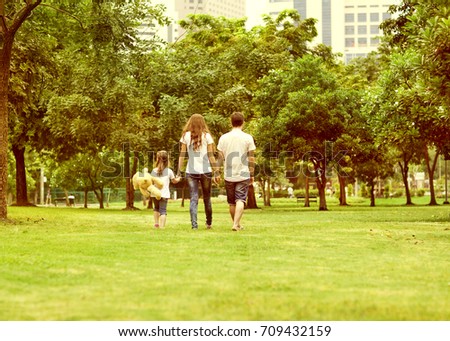 
Family walk in the park, happy at sunset in Bangkok, Thailand.