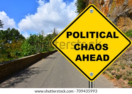 Political chaos ahead yellow warning street sign