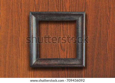 picture frame with space on brown wooden wall background