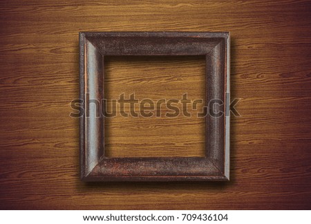 picture frame with space on brown wooden wall background