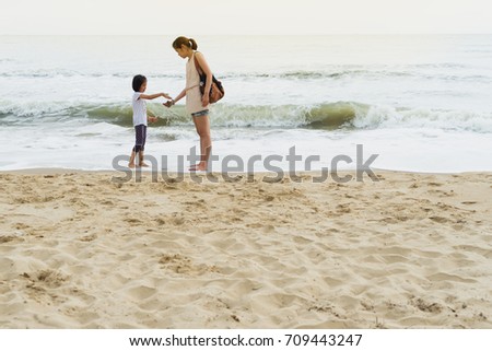 mother and child relationship play beach front 