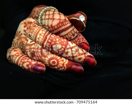 Bride- beautiful muslim bride hand with henna and ring (mehndi hands)