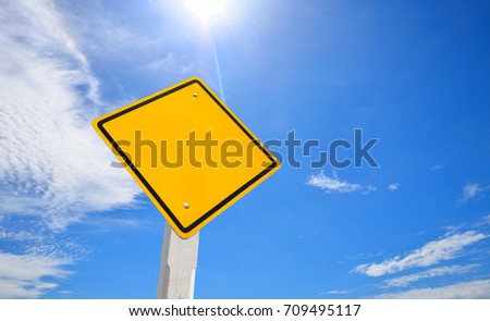 Blank yellow traffic sign, empty road sign with blue sky background. Conceptual image.