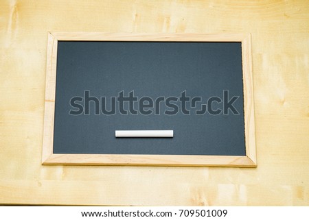 Empty chalkboard for text on wooden background.