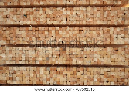 lumber wood at sawmill stacked in square chops