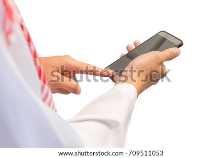 Close up of Arab Middle Eastern Businessman using mobile smartphone on white background Royalty-Free Stock Photo #709511053