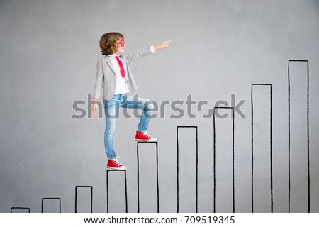 Child pretend to be businessman. Child rising up drawn chart bar. Imagination, idea and success concept. Back to school Royalty-Free Stock Photo #709519345