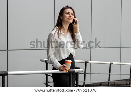 beautiful happy business woman standing and talking on the phone