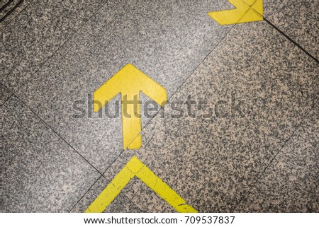 Left arrow symbol on the stone floor.