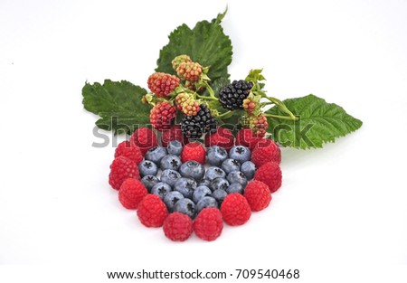 close up of fresh mix berries in a shape of heart isolated in white background 