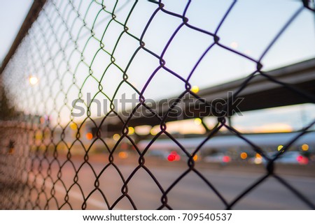 Chain fences Barrier between the corridors and highway road. (Blur focus)