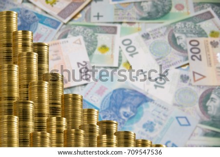 Rows of golden coins isolated on polish banknotes background. Backslash  decoration with money.