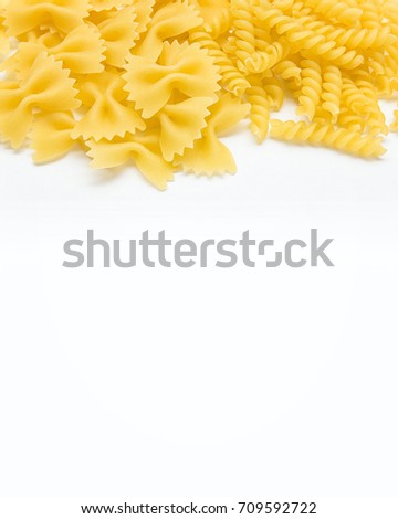 Pasta spiral or fusilli and farfalle close-up,  copy space on white background