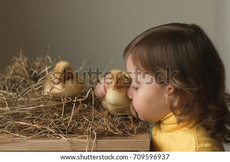 Little girl with a duckling
