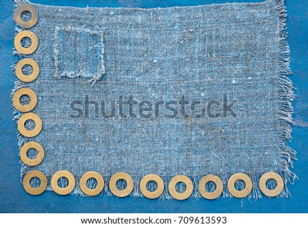 Abstract grunge background. Metallic rings washers on sackcloth
