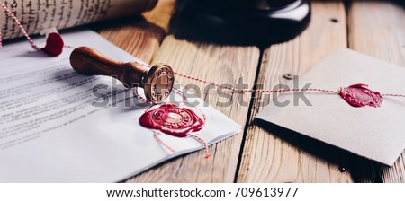 Notary public wax stamper and wax seal on document Royalty-Free Stock Photo #709613977