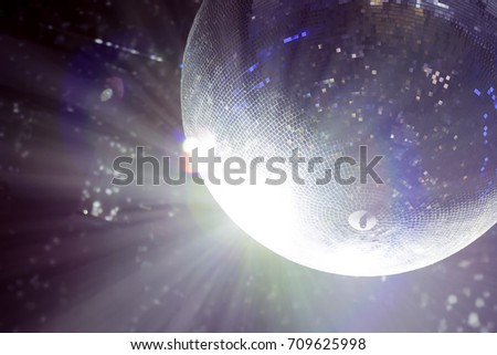 Bright patches of light on disco ball. The light at the party, the colored reflection of the mosaic glass ball disco