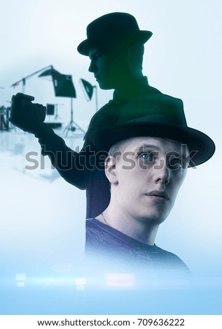 Male holding digital camera. Photo studio on background (movie poster style)