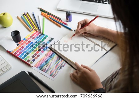 Artist creative graphic designer working on creative desk.