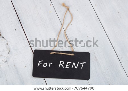 Blackboards with inscription "For Rent" on white wooden background