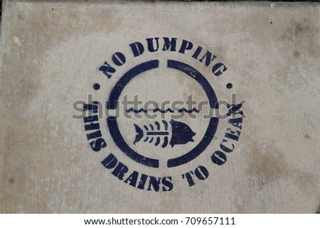 Cement stencil warning people not to dump. Santa Monica, CA.