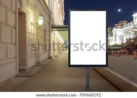 Blank street billboard at night city. Isolated with clipping path around advertising display. 