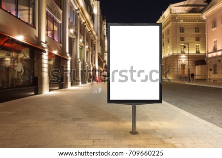 Blank street billboard at night city. Isolated with clipping path around advertising display. 