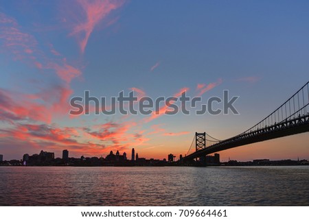 Ben Franklin bridge and Philadelphia skyline with dramatic red clouds