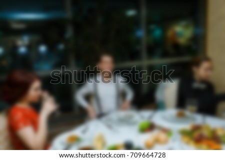 Blurred people at birthday party.