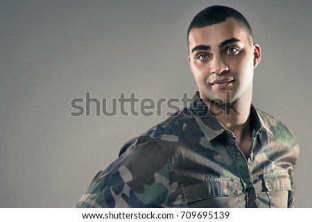 Portrait of handsome african american man looking at camera, studio shot.