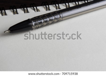 close up of blank spiral notebook with pen. selective focus 